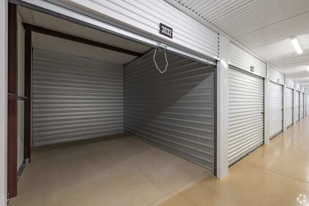 West-Henly-Self-Storage-Facility-Spacious-Storage-Unit-for-Rent-in-Johnson-City-Texas Interior of a clean, well-lit self-storage facility of West Henly Storage with roll-up storage unit doors.
